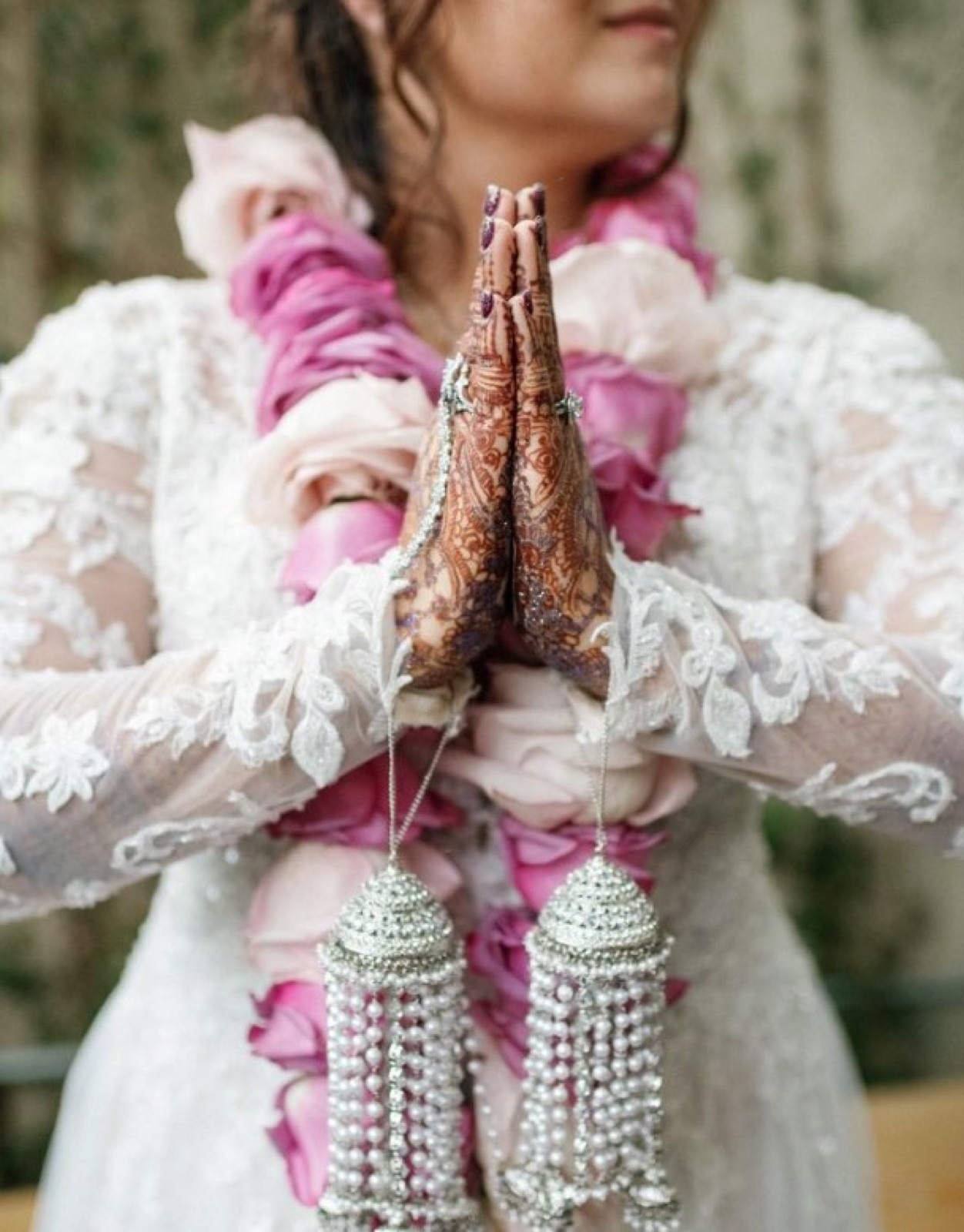 Bride with henna and a pink floral garland at an Indian-Western fusion wedding coordinated by April Hertz